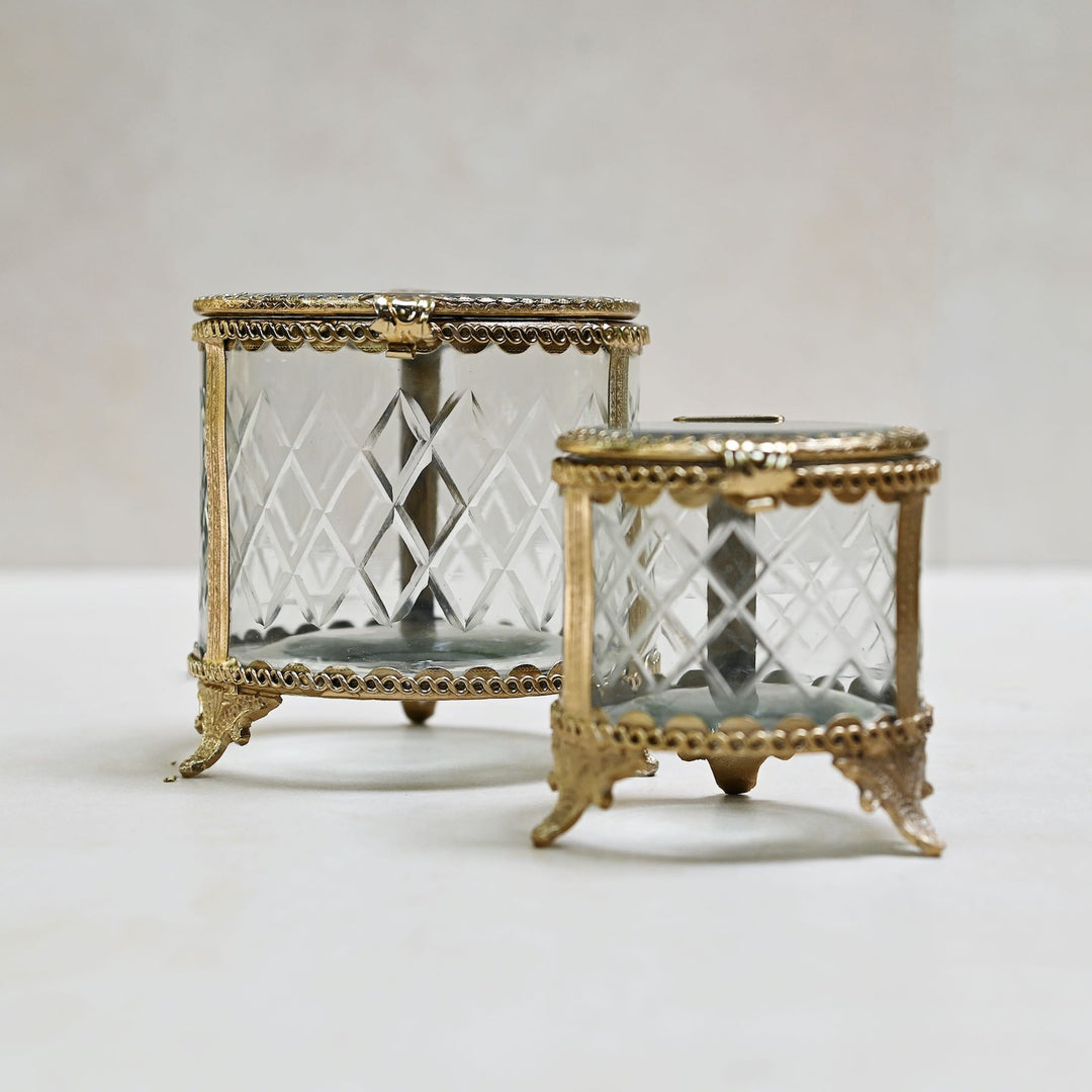 brass and glass jewellery box with a hinged lid and intricate detailing.