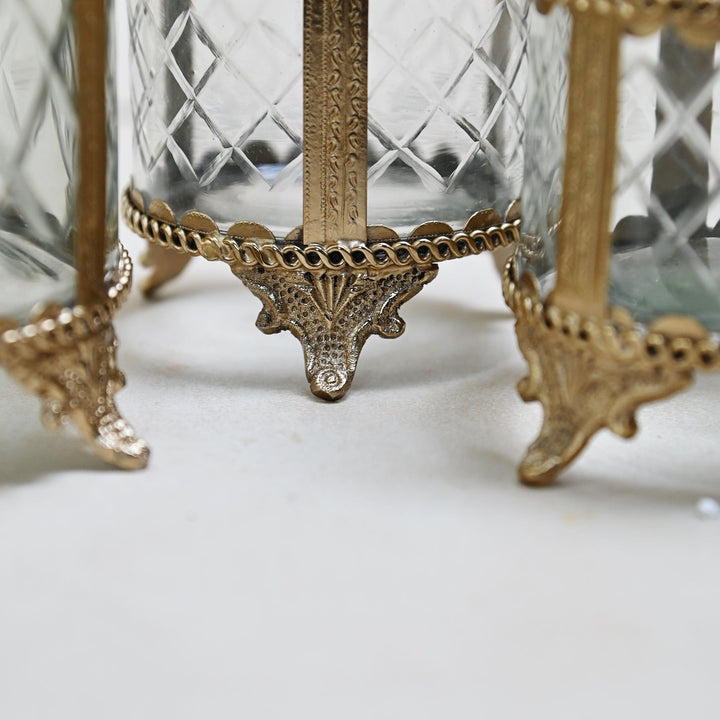 brass and glass jewellery box with a hinged lid and intricate detailing.