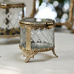 brass and glass jewellery box with a hinged lid and intricate detailing.