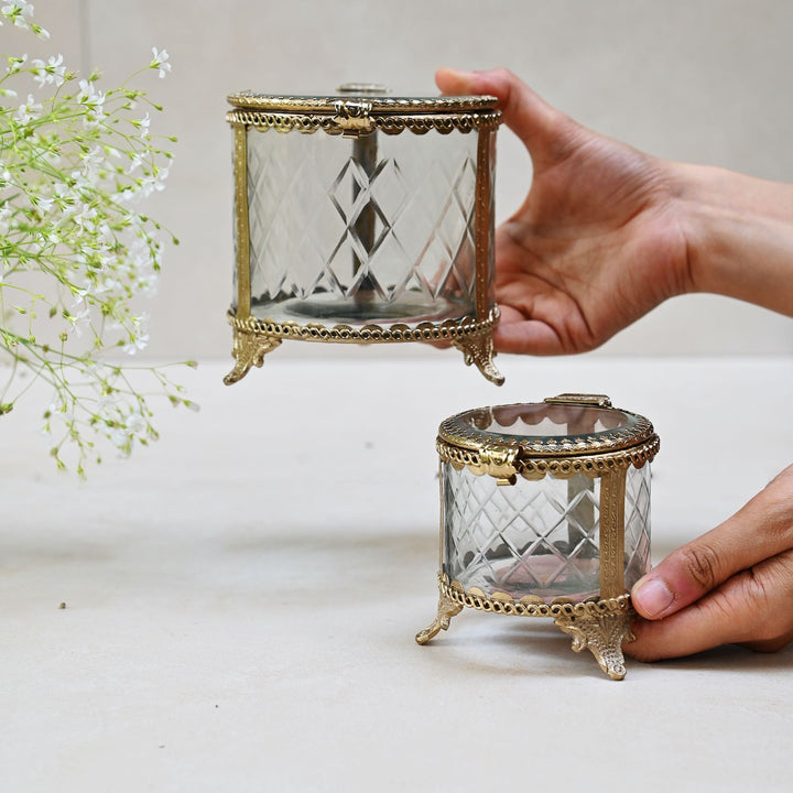 brass and glass jewellery box with a hinged lid and intricate detailing.