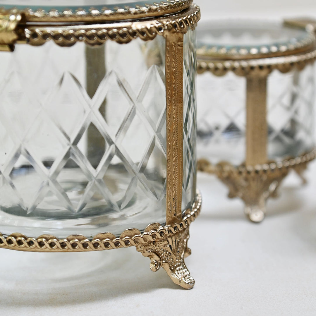 brass and glass jewellery box with a hinged lid and intricate detailing.