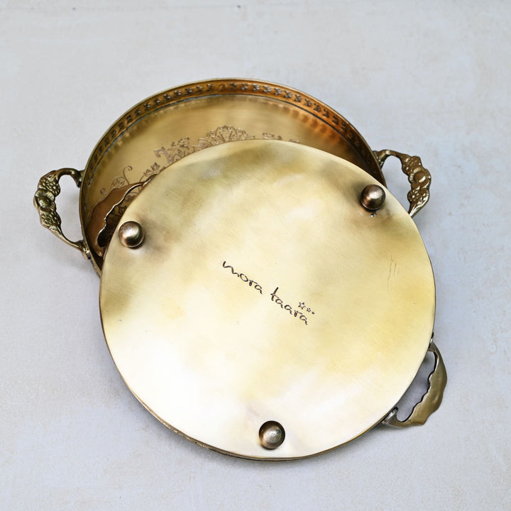 Decorative antique gold tray with Mora Taara logo etched at the bottom