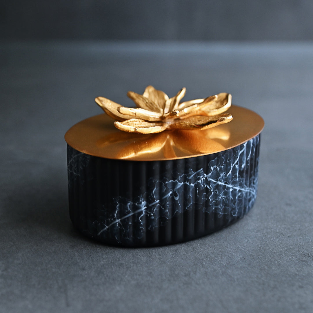black ornamental box with golden lid