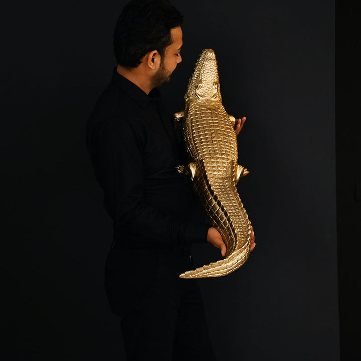 Gold crocodile sculpture with intricate detailing