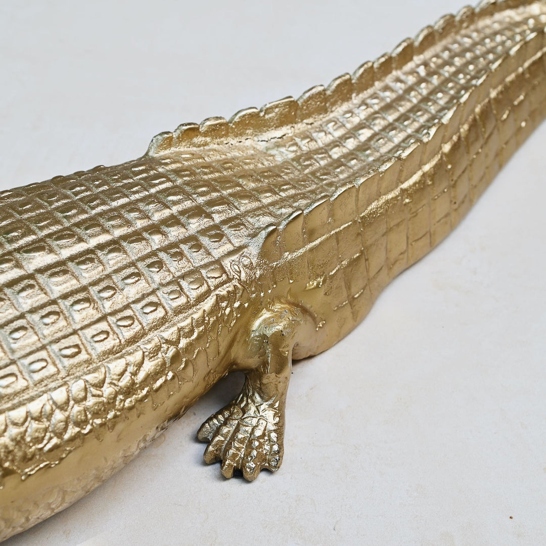 Gold crocodile sculpture with intricate detailing