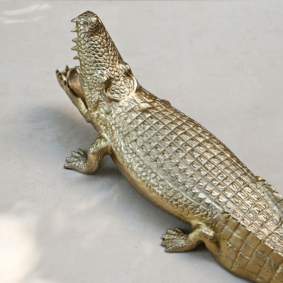 Gold crocodile sculpture with intricate detailing
