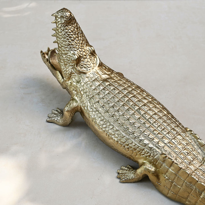 Gold crocodile sculpture with intricate detailing