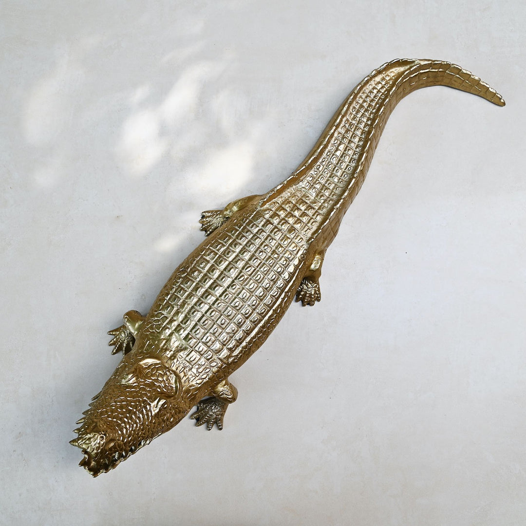 Gold crocodile sculpture with intricate detailing