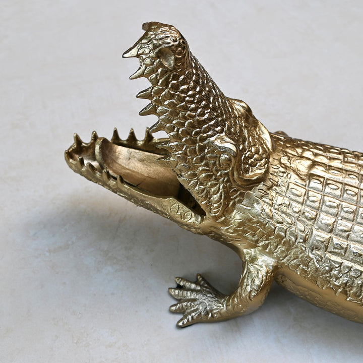 Gold crocodile sculpture with intricate detailing