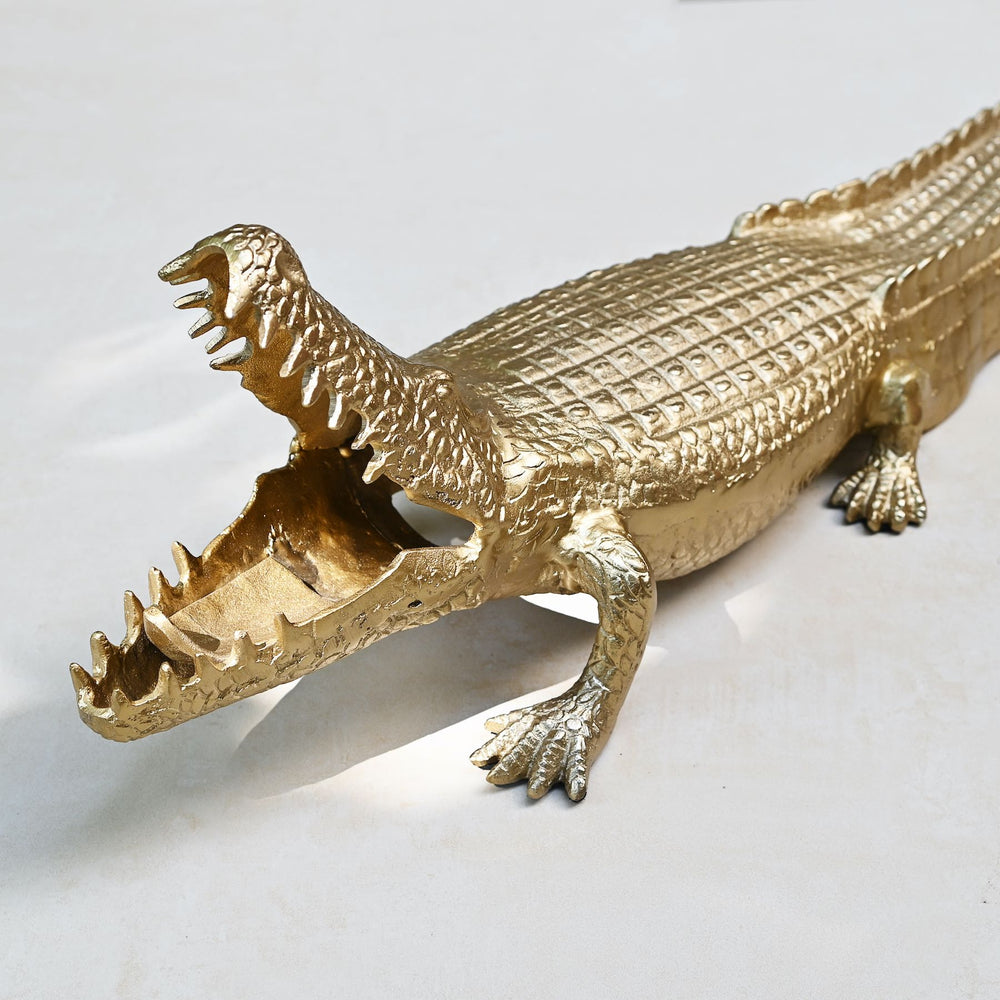 Gold crocodile sculpture with intricate detailing