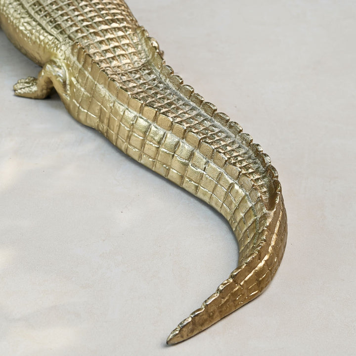 Gold crocodile sculpture with intricate detailing