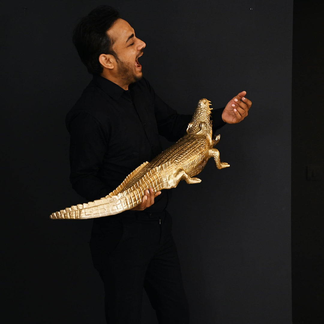 Gold crocodile sculpture with intricate detailing