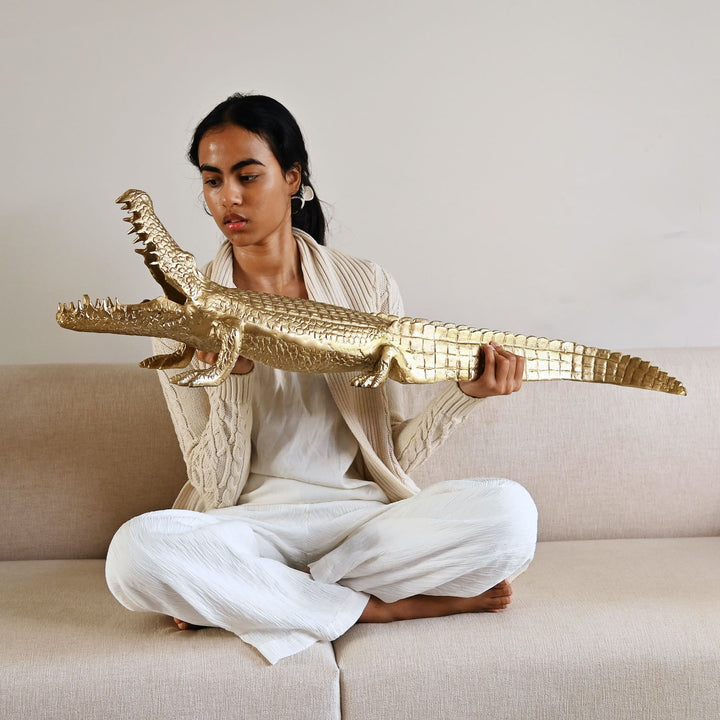 Gold crocodile sculpture with intricate detailing