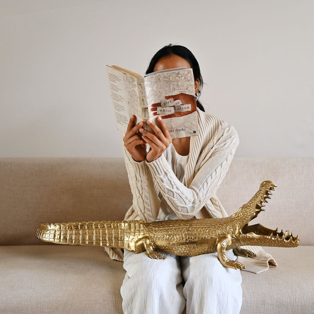 Gold crocodile sculpture with intricate detailing