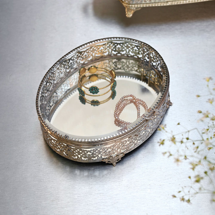 Large silver-finish glass oval box with brass edges and intricate detailing.