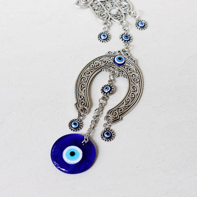 Turkish hanging horse shoe evil eye charm with blue glass