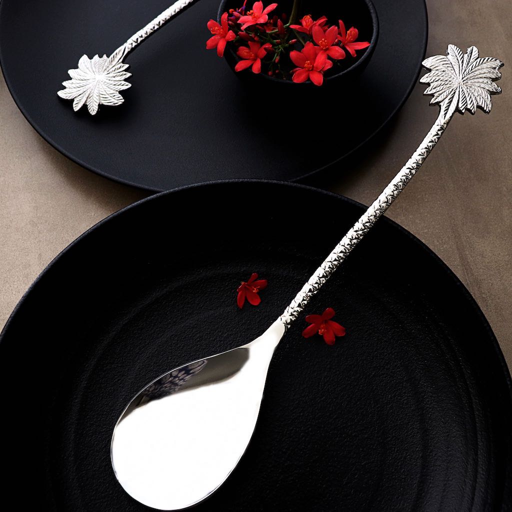 steel serving spoon with palm-leaf shaped handles