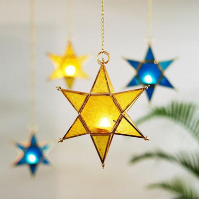 star shaped brass and glass yellow and blue t light holders