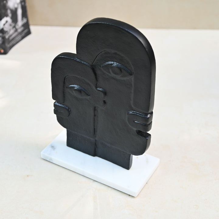 abstract face sculpture on marble base