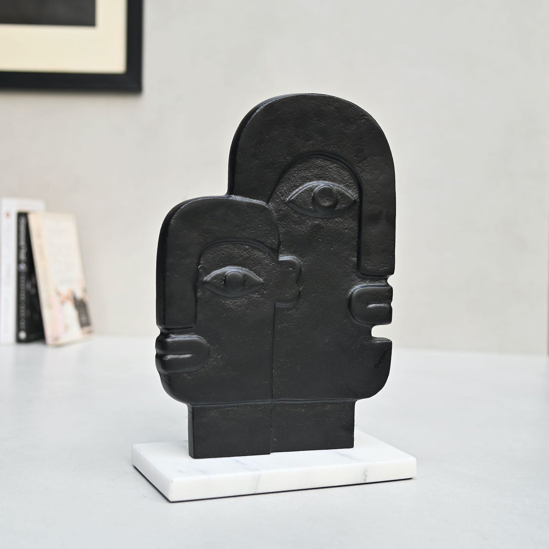 abstract face sculpture on marble base