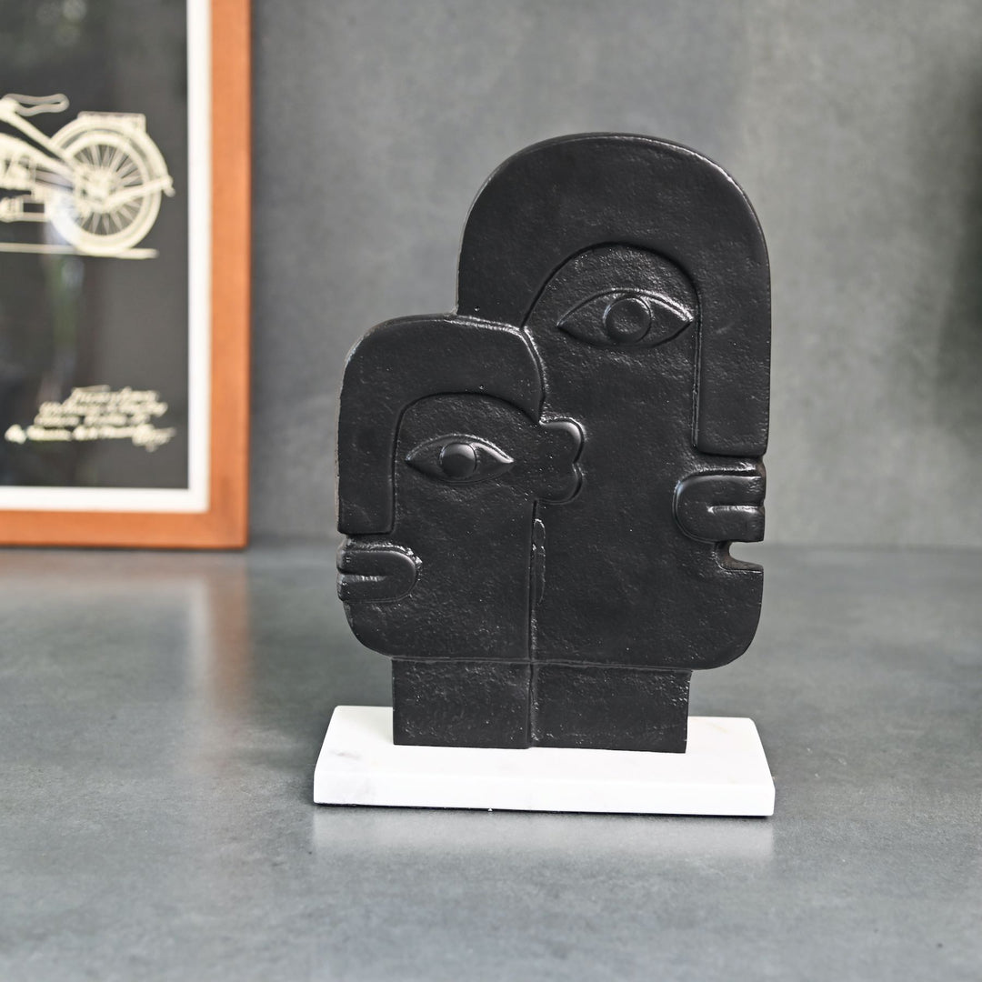 abstract face sculpture on marble base