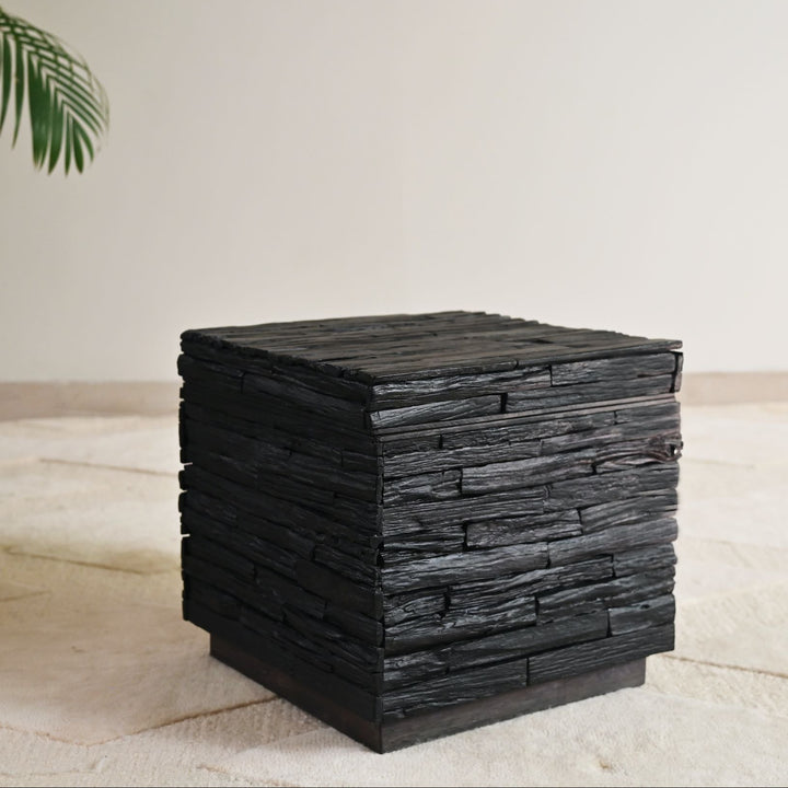 Black wooden side table with lift-top storage.