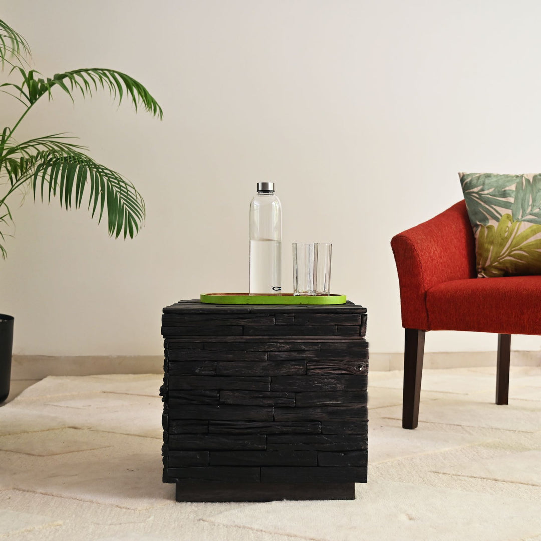 Black wooden side table with lift-top storage.