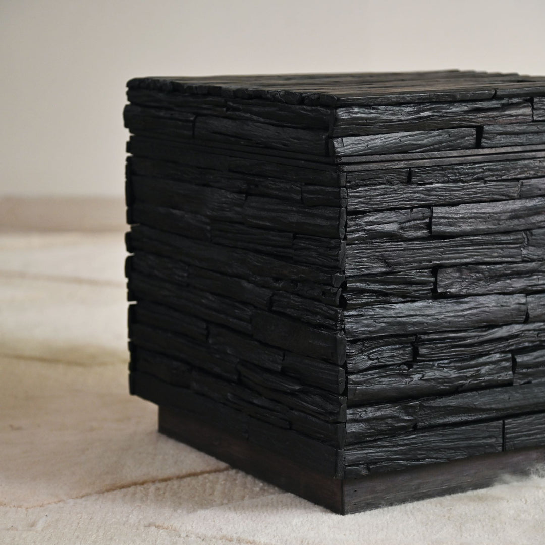 Black wooden side table with lift-top storage.