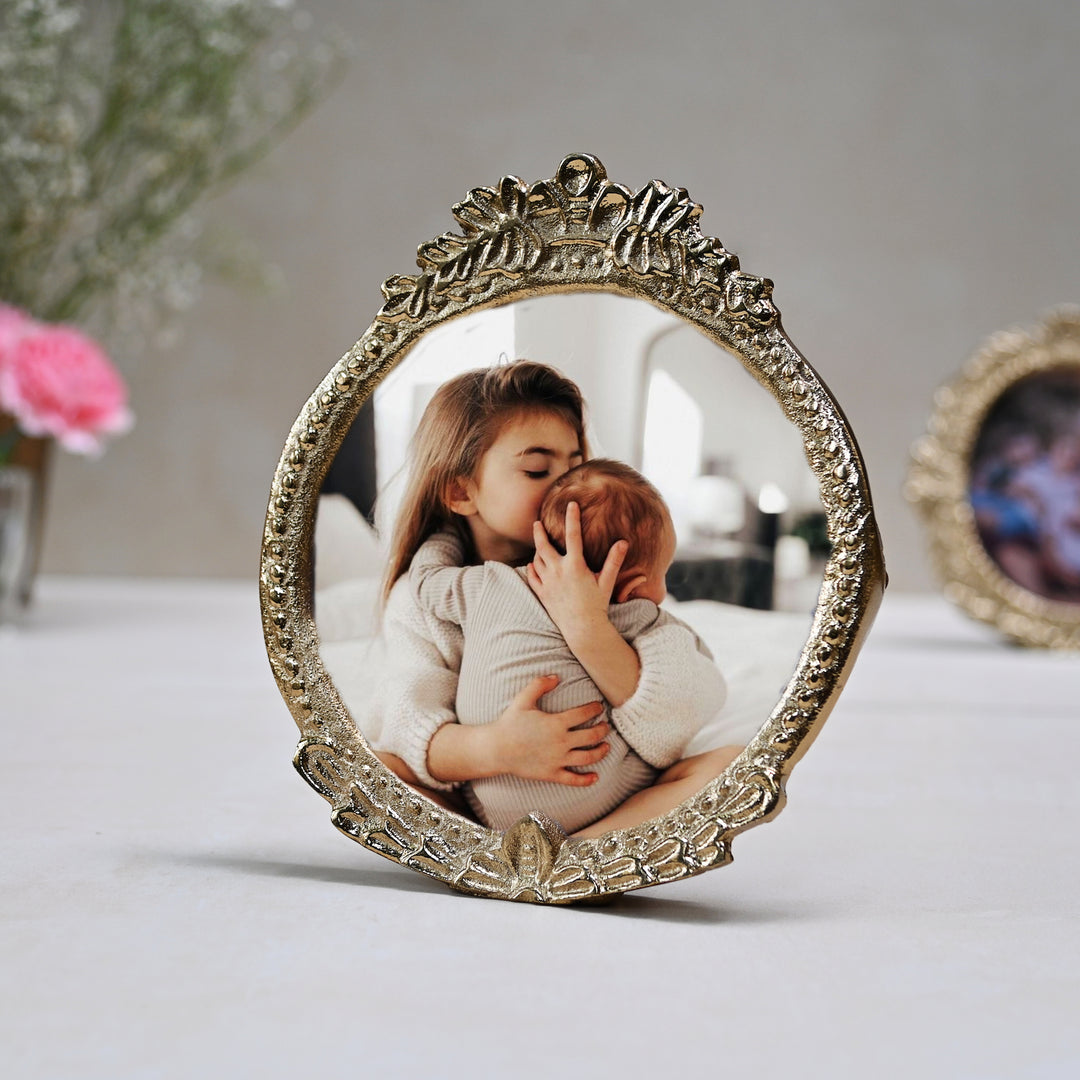 small golden oval photo frame