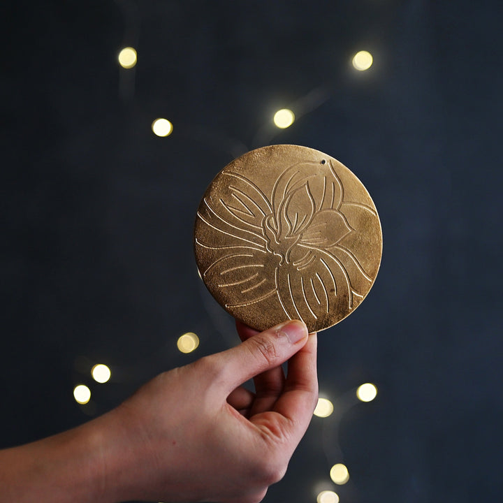 golden coaster with floral motif