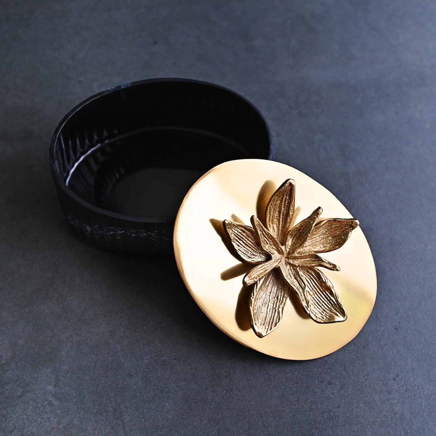 black ornamental box with golden lid