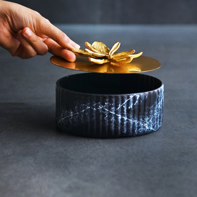 black ornamental box with golden lid