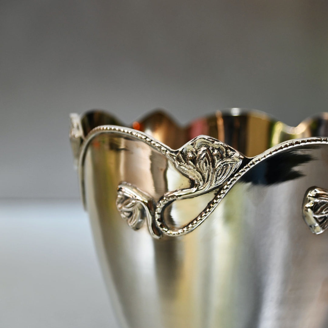 Decorative silver brass bowl with intricate designs on a neutral background