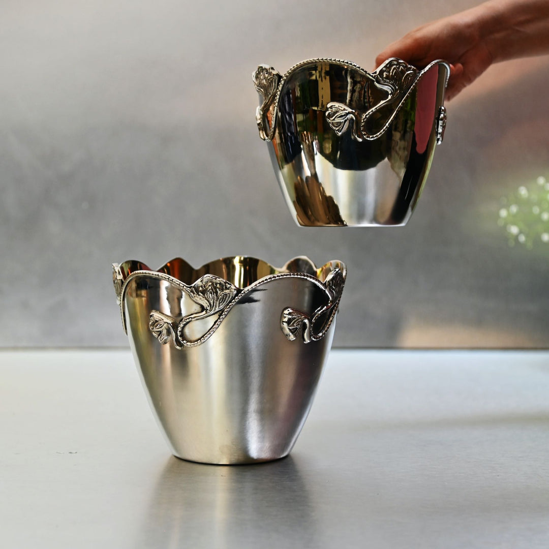 Tapered silver planters with stainless steel finish and decorative detailing.
