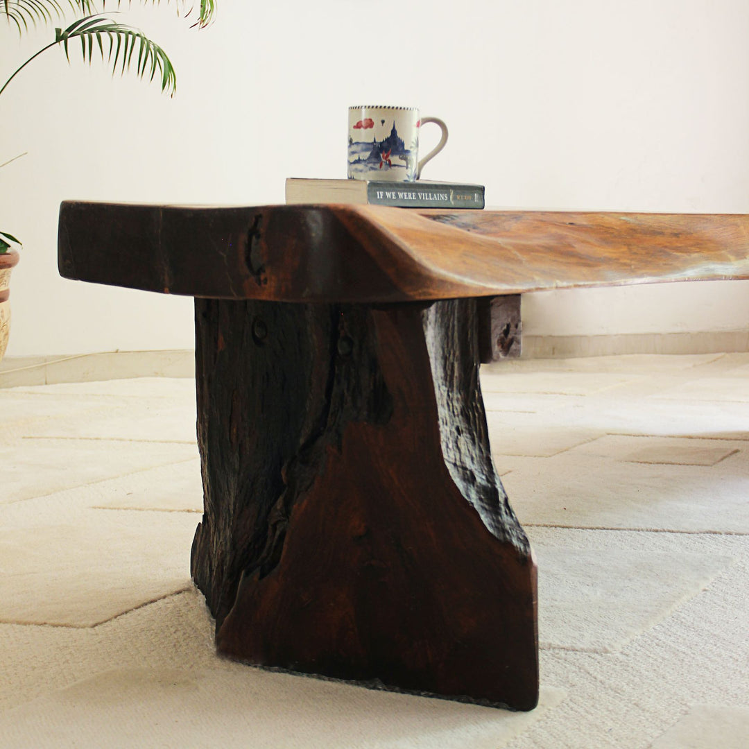 Wooden table with a natural, rustic design on a light wooden floor.