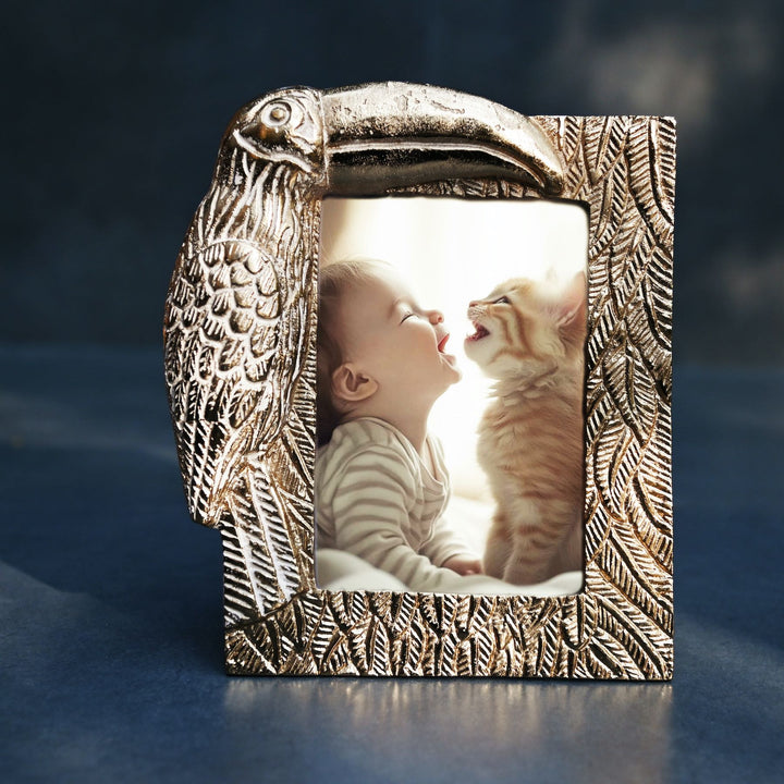 golden photo frame with toucan