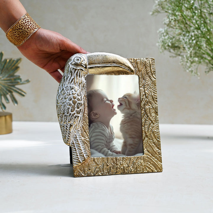 golden photo frame with toucan