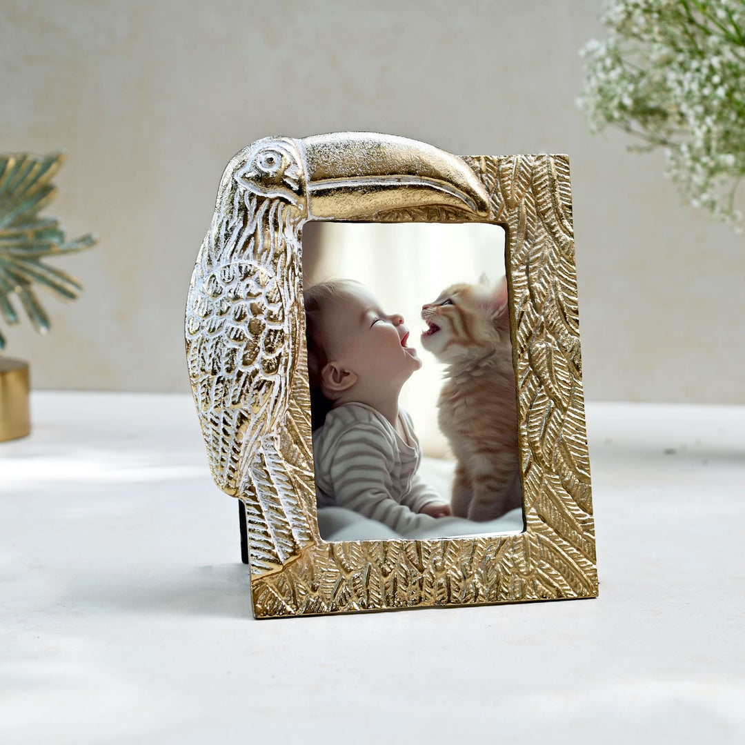 golden photo frame with toucan