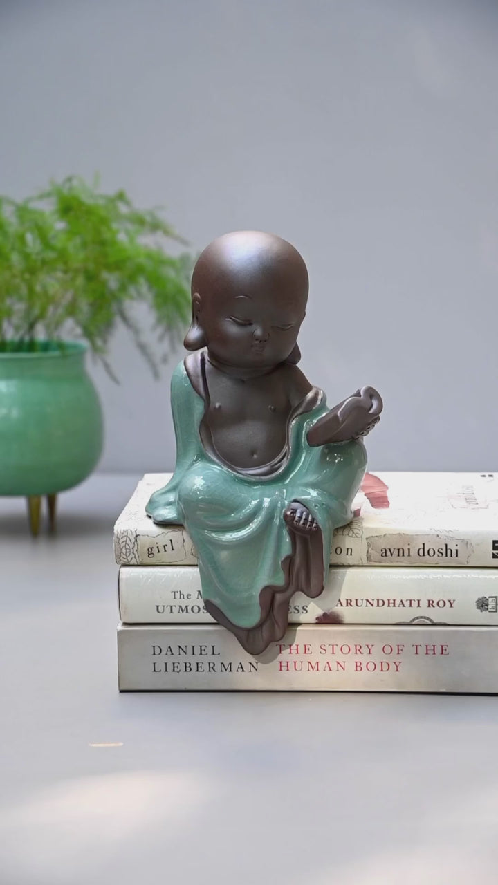 Ceramic Buddhist Monk Figurine with Book