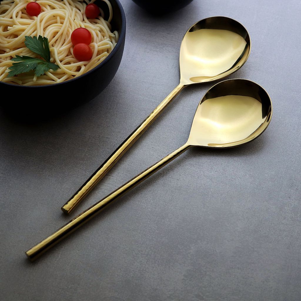 gold-coloured serving spoons