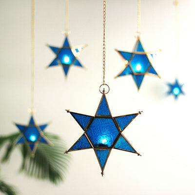 star shaped brass and glass blue t light holders