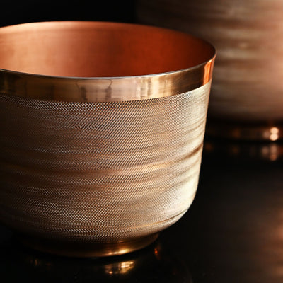 round metal planter with copper finish