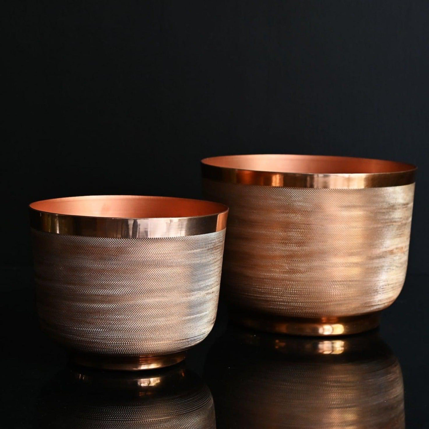 round metal planter with copper finish