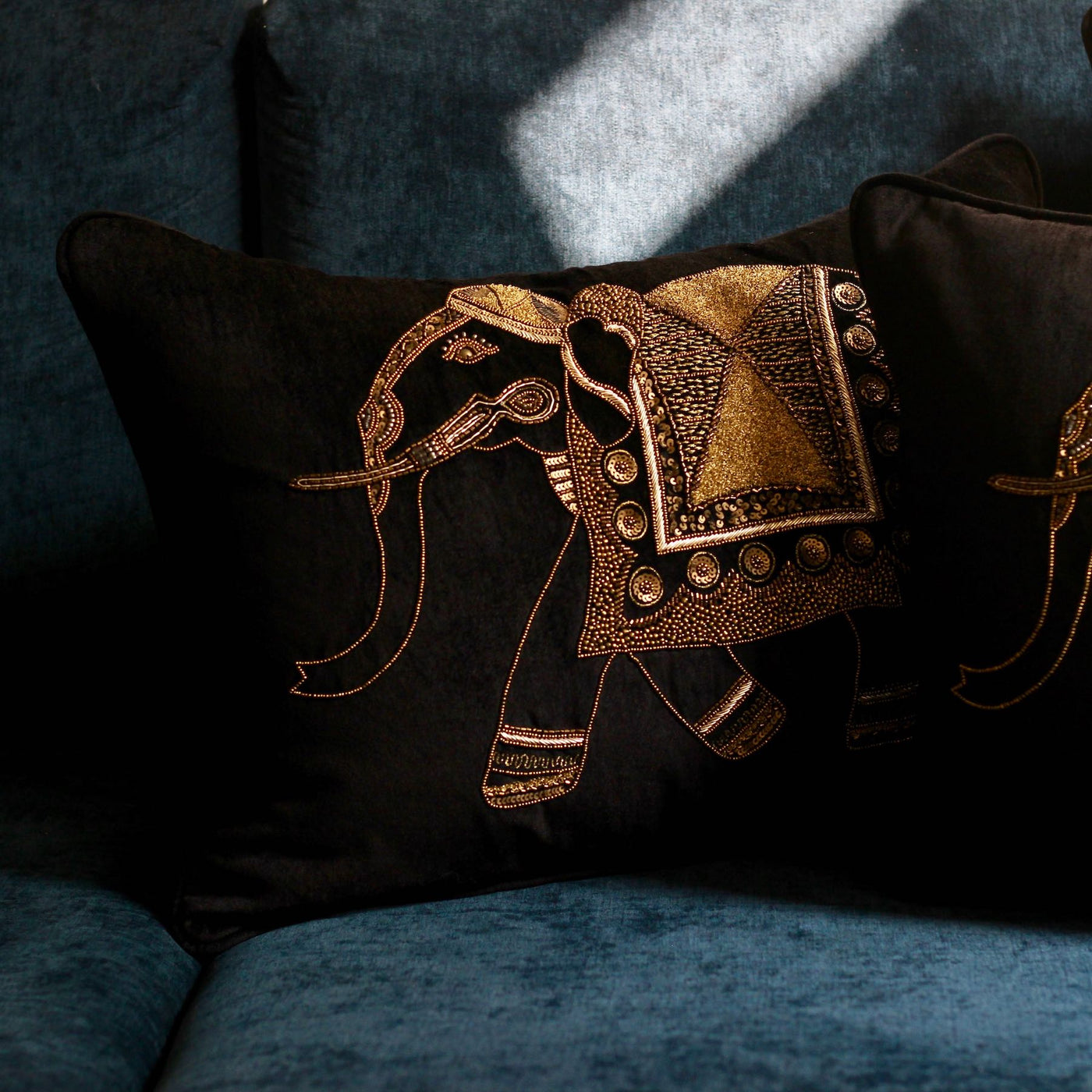 black velvet sofa cushion with golden embroidered elephant design
