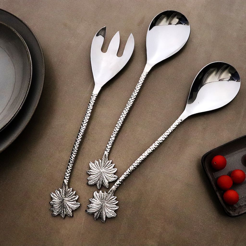 steel serving cutlery with palm-leaf shaped handles