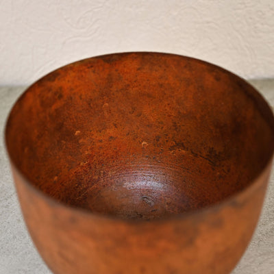 rust brown metal planter with legs