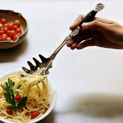 pasta server with black inlay handles